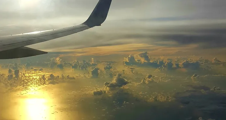 Plane wing in the clouds